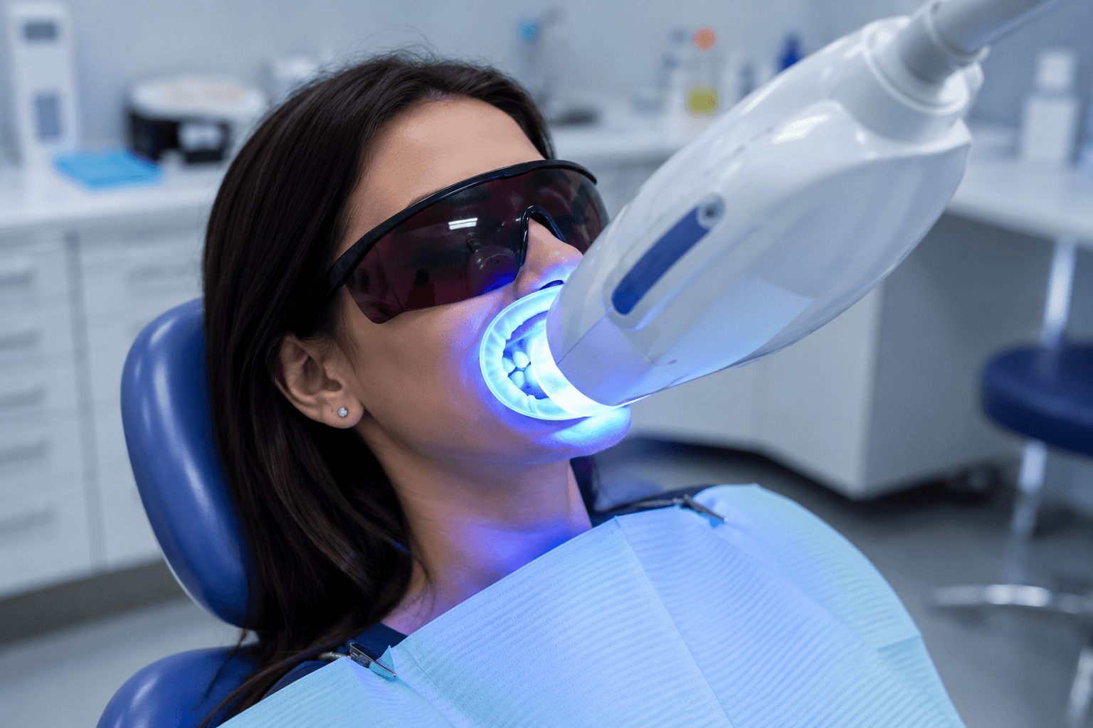 Blue LED whitening lamp positioned over patient mouth during treatment